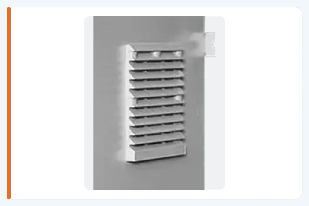 Close-up of a louvered ventilation opening on an electrical enclosure side panel