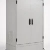 Outdoor floor-standing electrical enclosure cabinet with double front doors, a sloped rain hood, side ventilation louvers, and a plinth base.