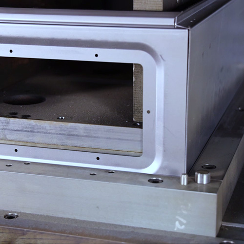 Stamped sheet metal enclosure panel with ventilation and mounting openings