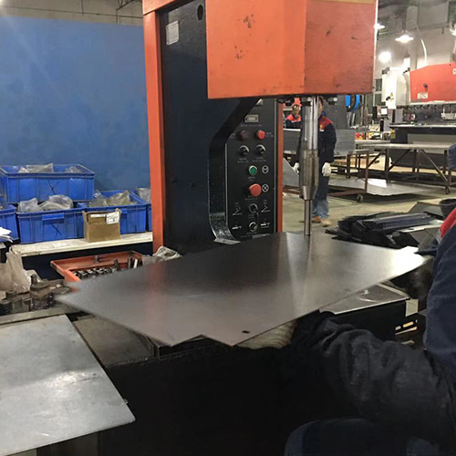 Press riveting machine installing fasteners in an enclosure panel