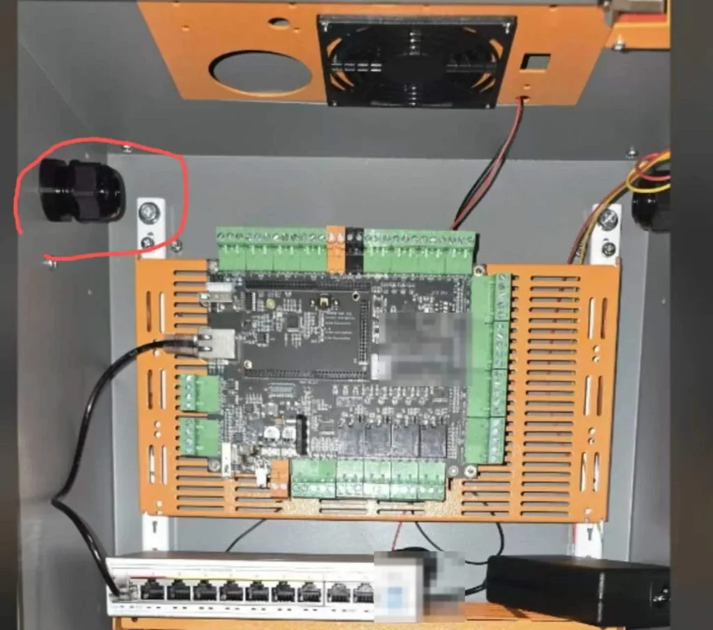 Controller, terminals, network switch, fan, and cable entries fitted inside an outdoor IoT enclosure