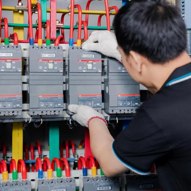 Electrical engineer installing circuit breakers in a distribution panel