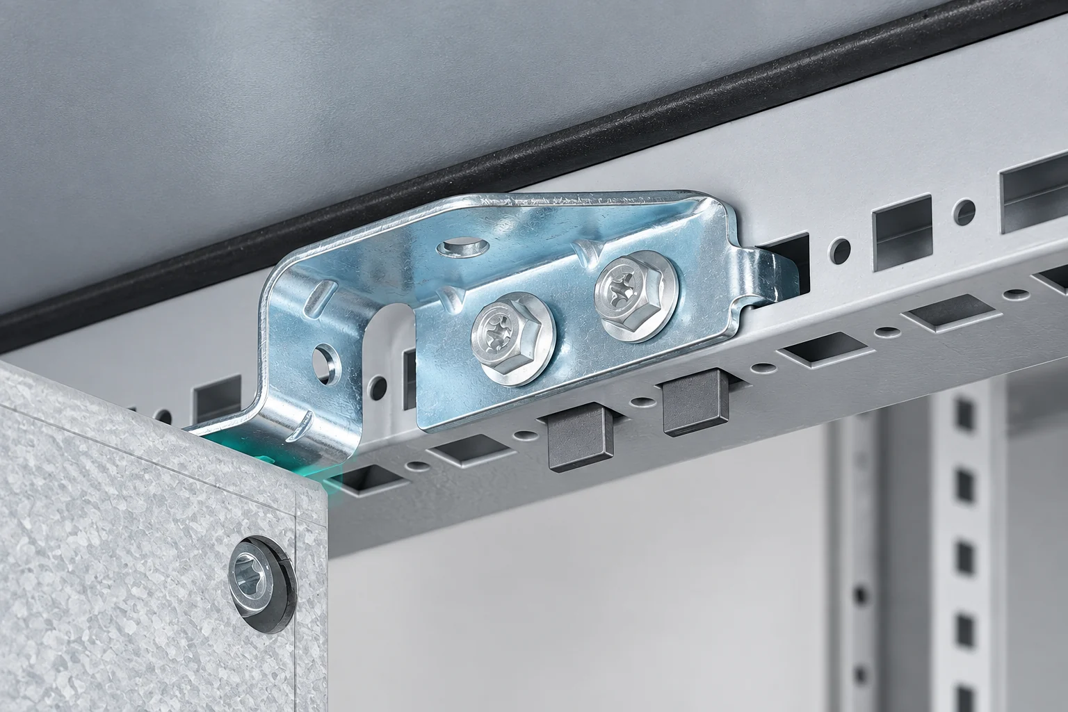 Cabinet mounting plate bracket and screw fixings on a perforated frame rail.